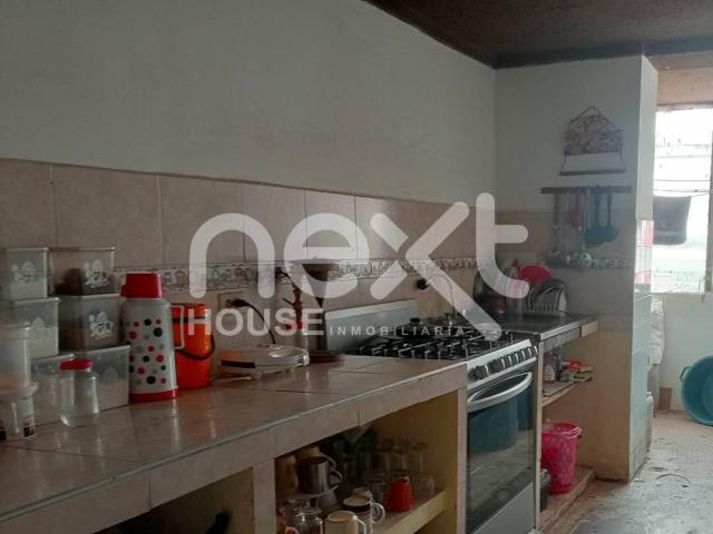 Cocina con la zona del lavadero al fondo tras esa pared
